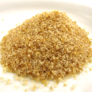 a pile of tan granules on a white backgorund