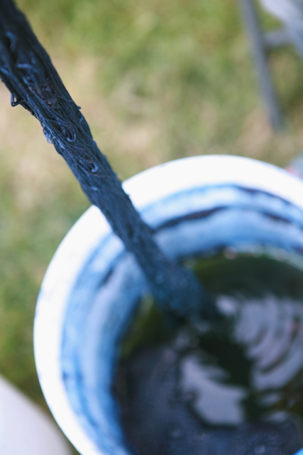 blue yarn over an indigo vat in a white bucket
