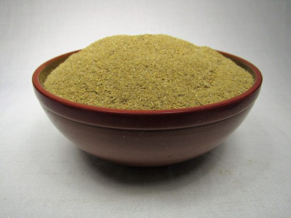 A yellow-green powder sits in a red bowl