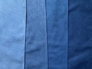 Four strips of cotton in varying shades of blue, from lightest on the left to darkest on the right