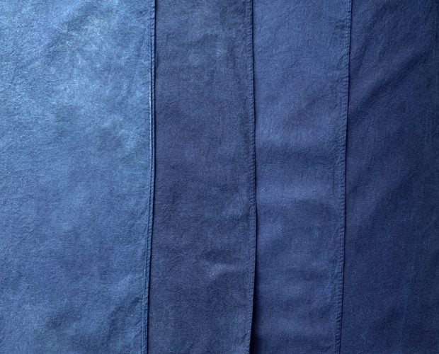 Four strips of cotton in varying shades of blue, from lightest on the left to darkest on the right
