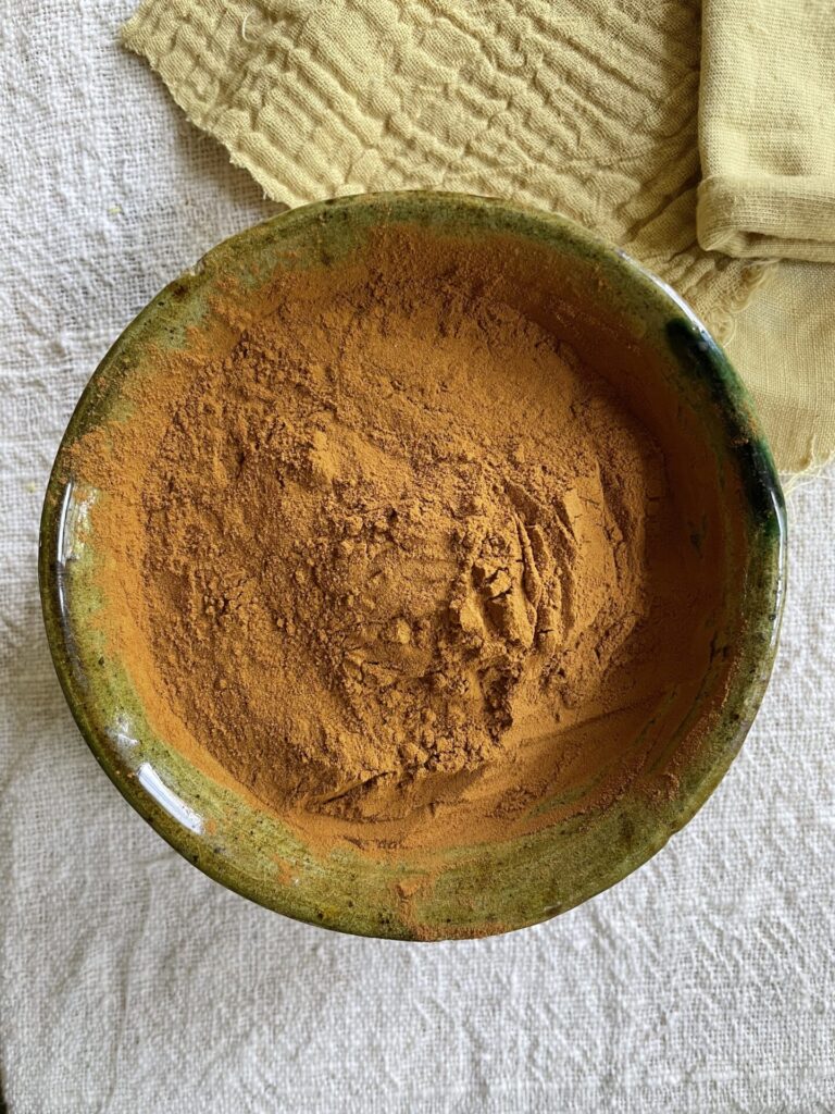 A bowl of fustic yellow dye powder.