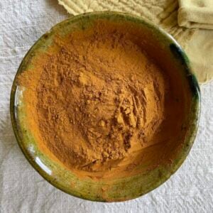 A bowl of fustic yellow dye powder.