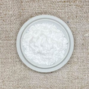 White powder on a white circular ceramic tray