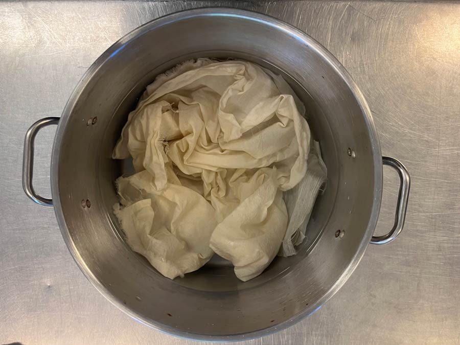 Undyed fibers floating in a clear mordant bath