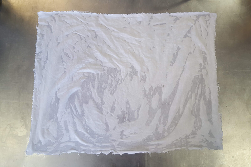 wet white fabric on a metal table