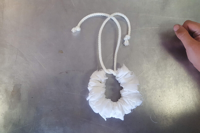 white fabric wrapped around rope which is tied in a knot