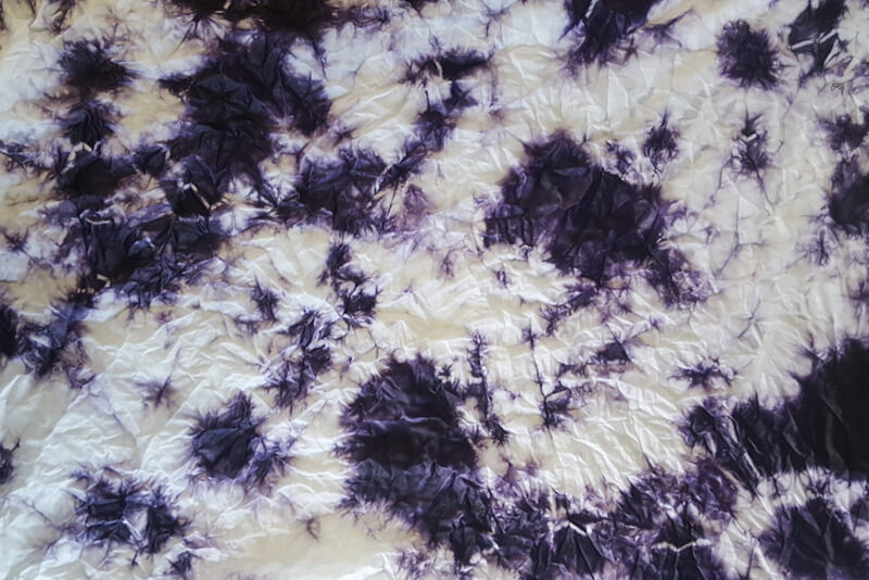 white and purple fabric dyed in an organic pattern