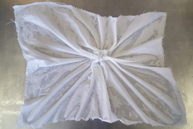 wet white fabric scrunched up in the middle