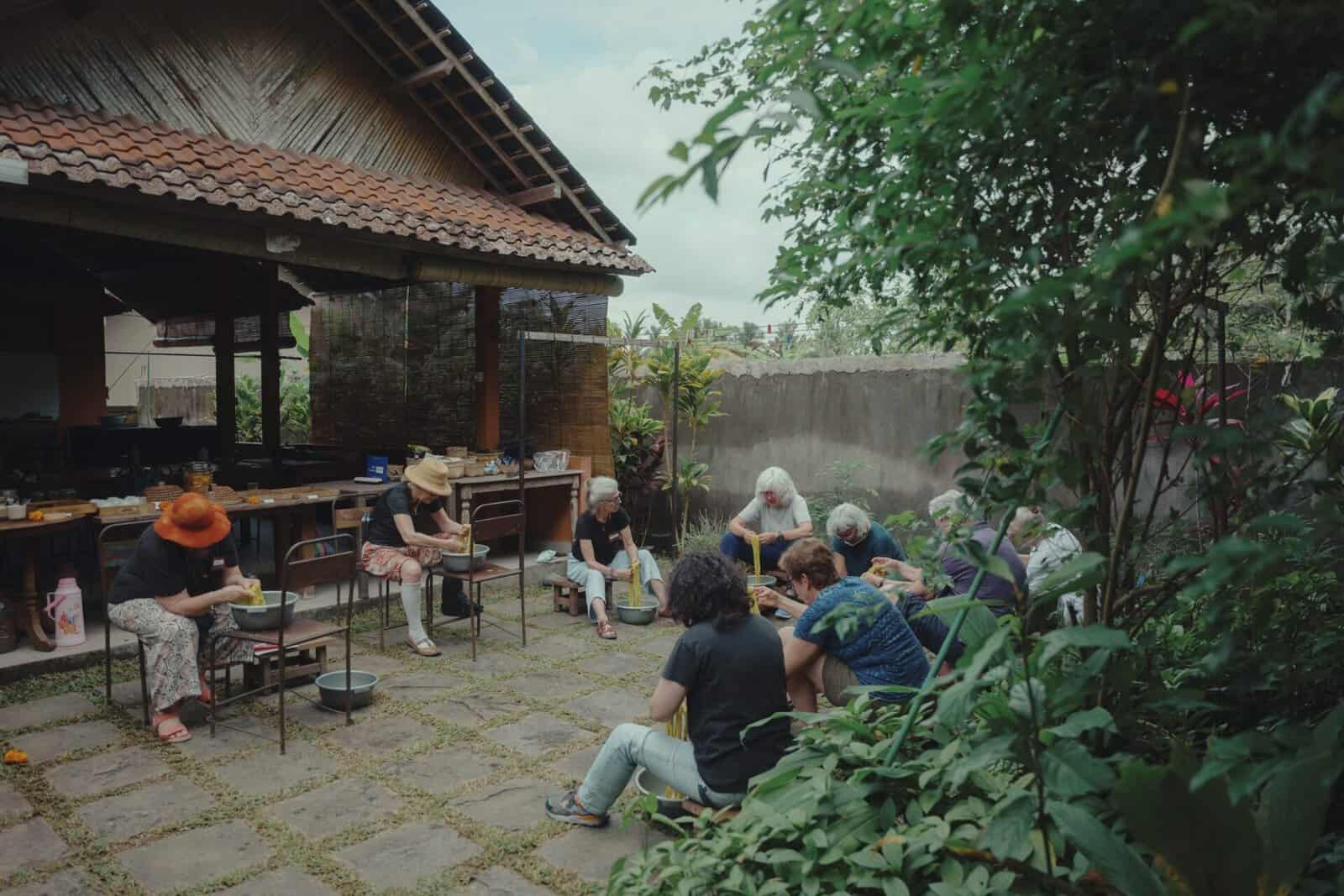 Participants working with dyed yarn in the studio courtyard