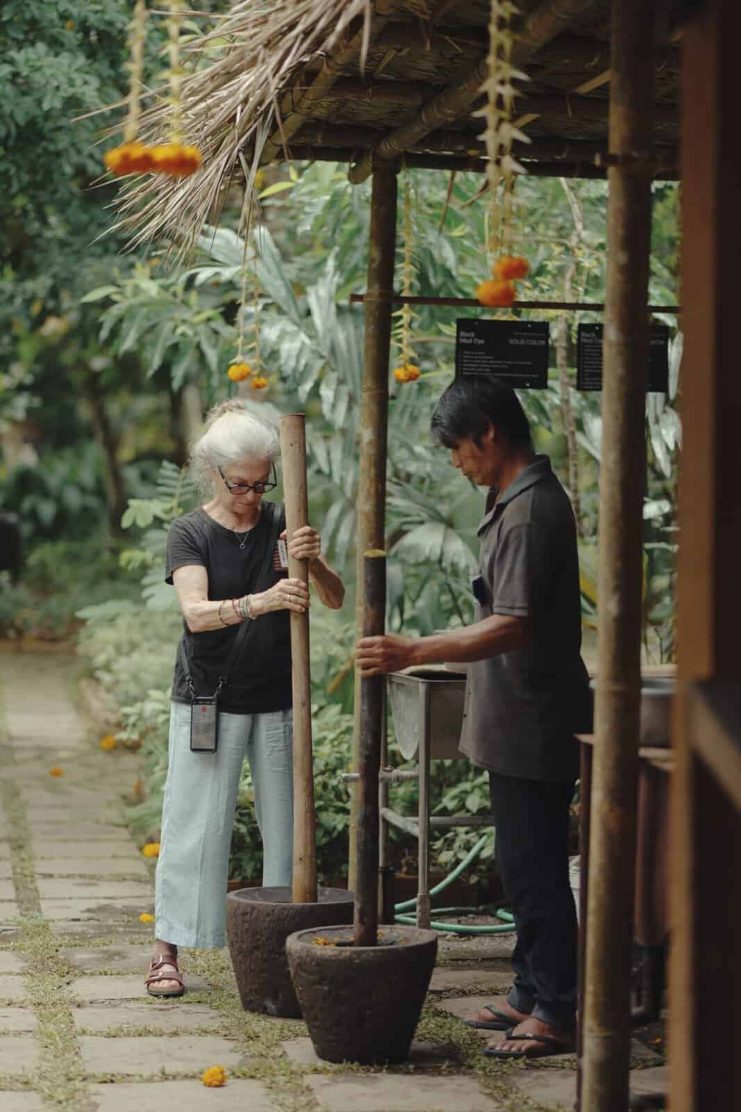 Pounding plant material for mud and tannin dyeing